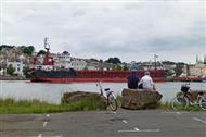 Cyclists watching a boat